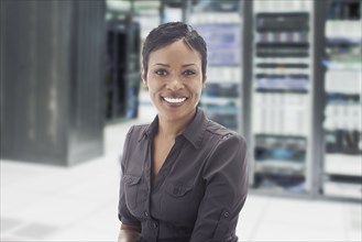 African American businesswoman in server room
