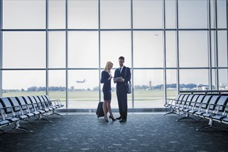 Caucasian business people standing in airport