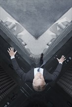 Caucasian businessman jumping off skyscraper
