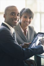 Black business people using tablet computer