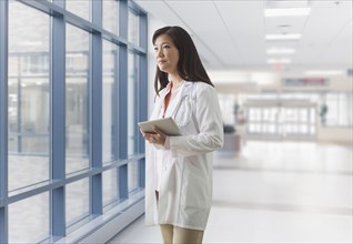 Asian doctor walking in hospital