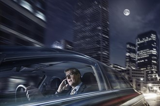 Caucasian businessman driving on cell phone