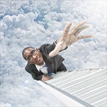 African American businessman climbing ladder