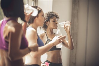 Women drinking water in gym