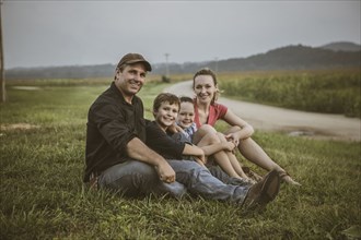 Caucasian family overlooking crop fields