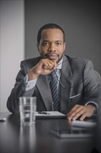 Mixed race businessman sitting in meeting