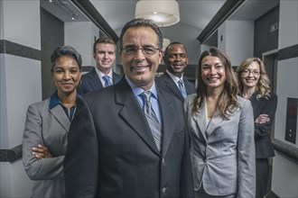 Business people smiling in office corridor