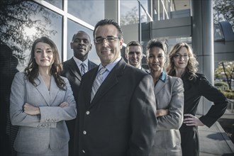 Business people smiling outside office building