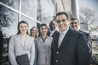 Business people smiling outside office building