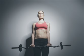 Caucasian woman holding barbell