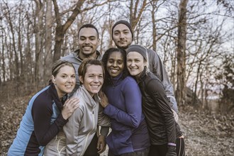 Runners smiling on forest path