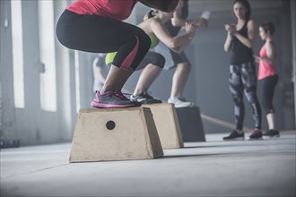 Athletes crouching on platforms in gym