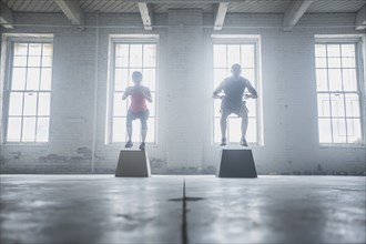 Silhouette of athletes jumping on platforms