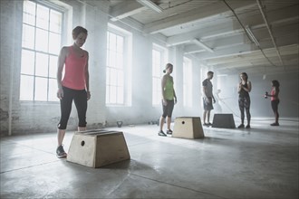 Athletes standing at platforms in gym