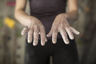 Close up of chalky hands of athlete in gym