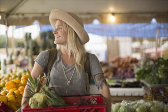 Caucasian woman shopping for produce in farmers market