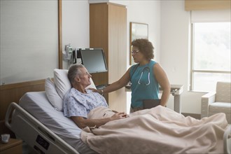 Doctor talking to patient in hospital room