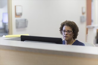 African American nurse using computer in hospital