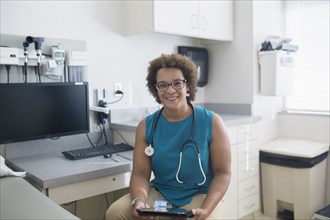 African American doctor using digital tablet