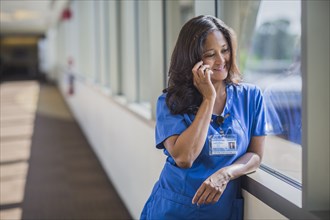 Filipino nurse talking on cell phone