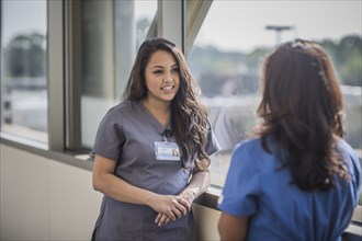 Nurses talking in hospital hallway
