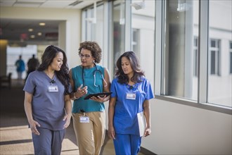 Nurses and doctor using digital tablet