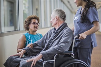 Doctor talking to patient in wheelchair