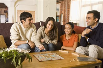 Multi-ethnic family playing board game