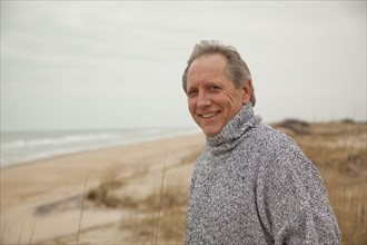 Caucasian man standing on beach