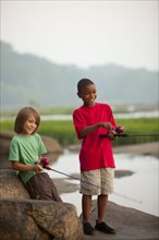 Smiling boys fishing together