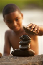 African American boy stacking rocks