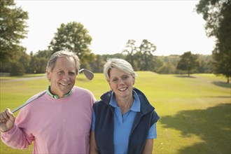 Couple standing on golf course