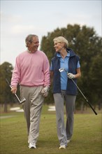 Couple walking on golf course