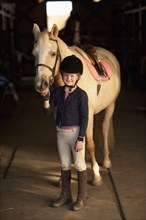 Caucasian girl standing with horse