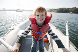 Caucasian boy rowing on boat