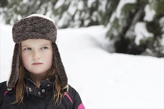Caucasian girl in cap in the snow