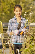 Japanese girl holding gardening trowel