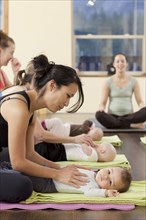 Mothers and babies taking yoga class