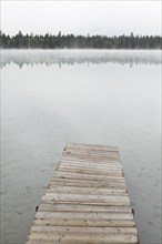 Dock on foggy lake