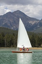 Caucasian boys and girl sailing on lake