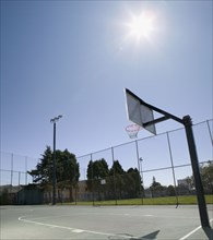Sun shining on basketball court