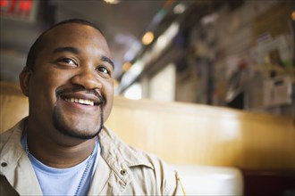 African man smiling in diner