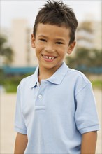 Mixed race boy smiling on beach
