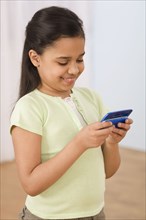 Hispanic girl using cell phone