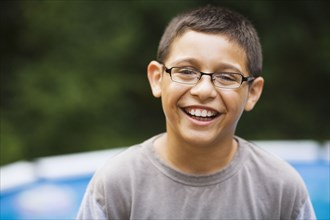 Smiling mixed race boy in eyeglasses