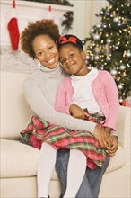 African mother hugging daughter at Christmas