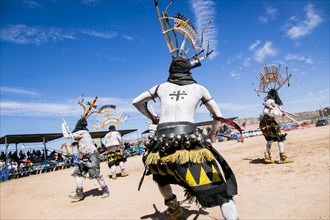 Apache men dancing in traditional regalia
