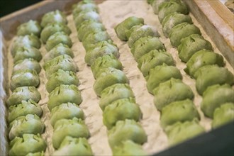 Tray of green dumplings