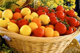 Basket of fresh lemons and tomatoes at market