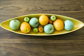 Bowl with fruit on wooden table